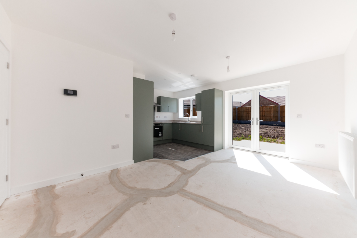 Kitchen, dining and living space with patio doors out into the garden