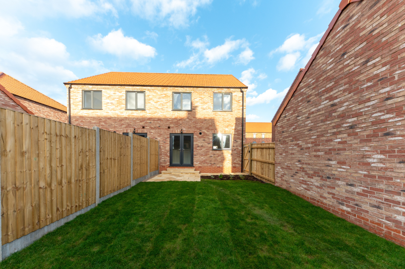 turfed garden looking towards a house