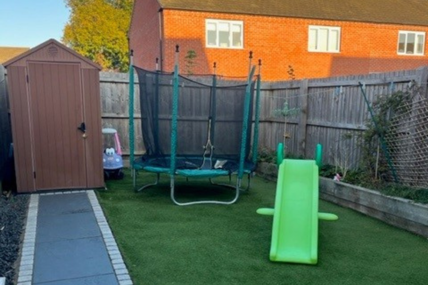 Garden with shed, slide and trampoline