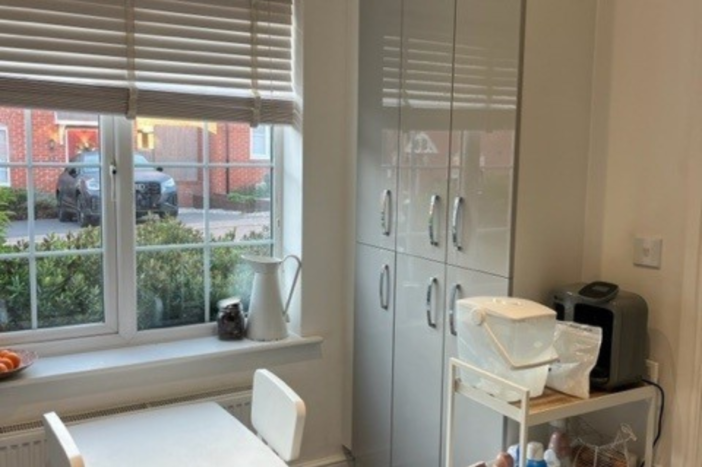 Dining table and cupboards next to a window