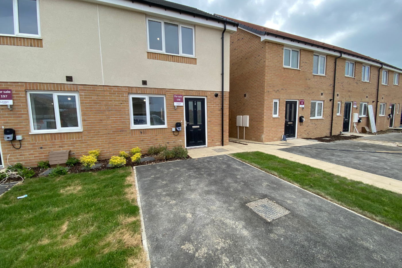 Front of a terraced row of houses with parking