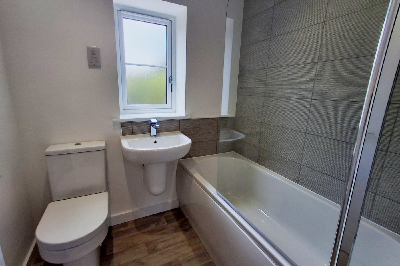 The bathroom showing toilet, sink, bath and shower