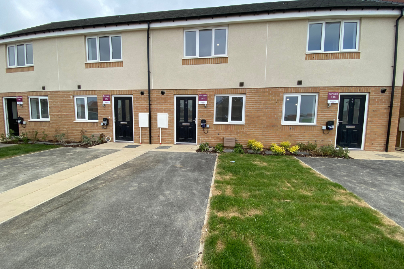 Front of a terraced row of houses with parking