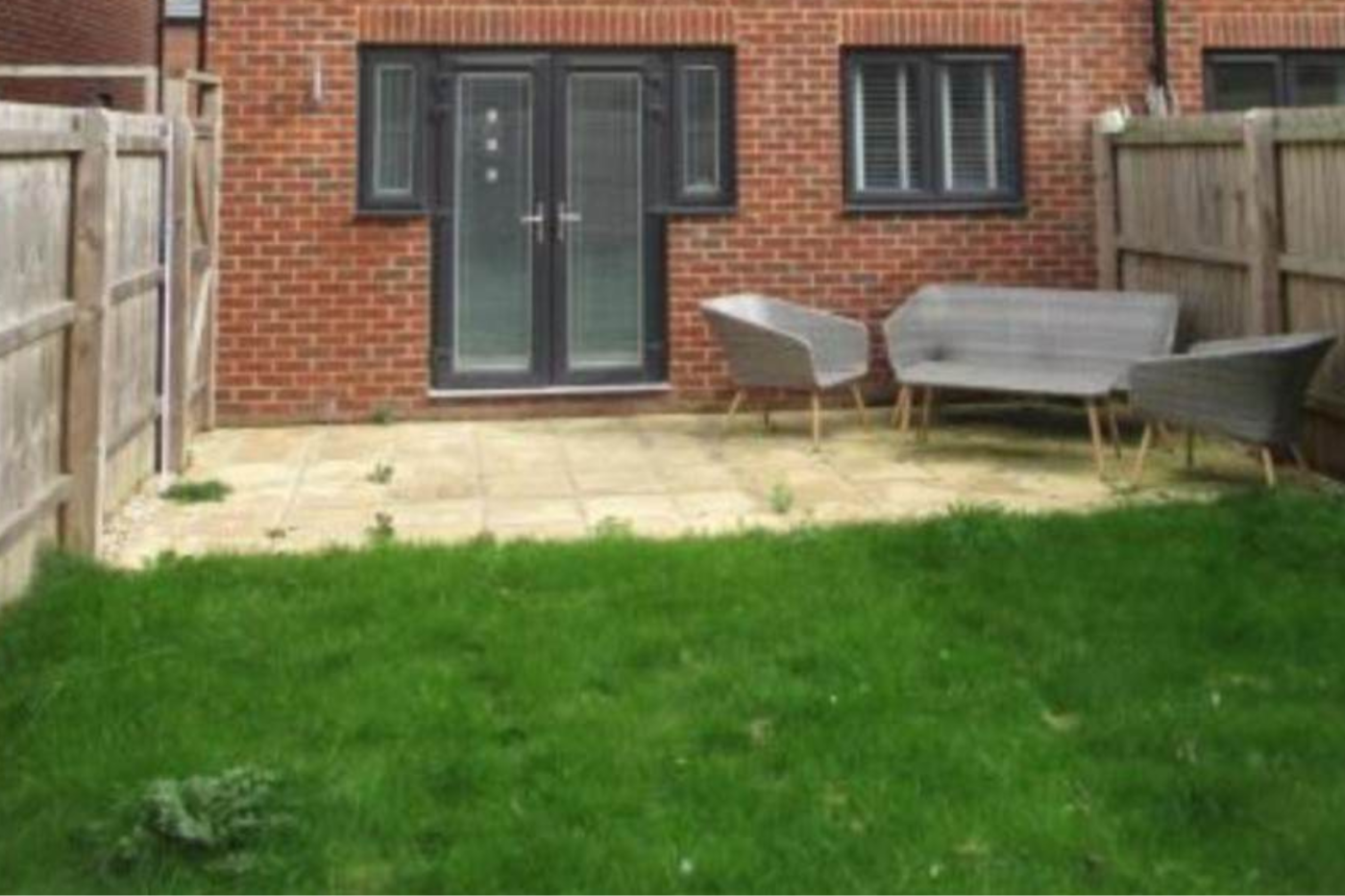 Rear elevation with patio and lawn