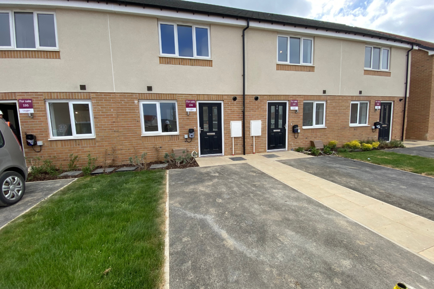 Front of a terraced row of houses with parking