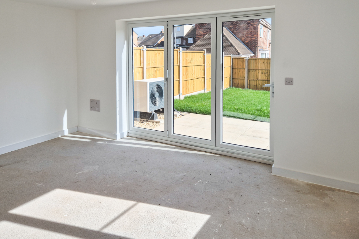 The kitchen showing bi fold doors leading to the enclosed rear garden