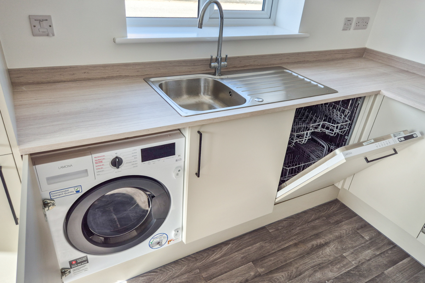 The kitchen showing the washing machine, dishwasher, sink, and kitchen worktop
