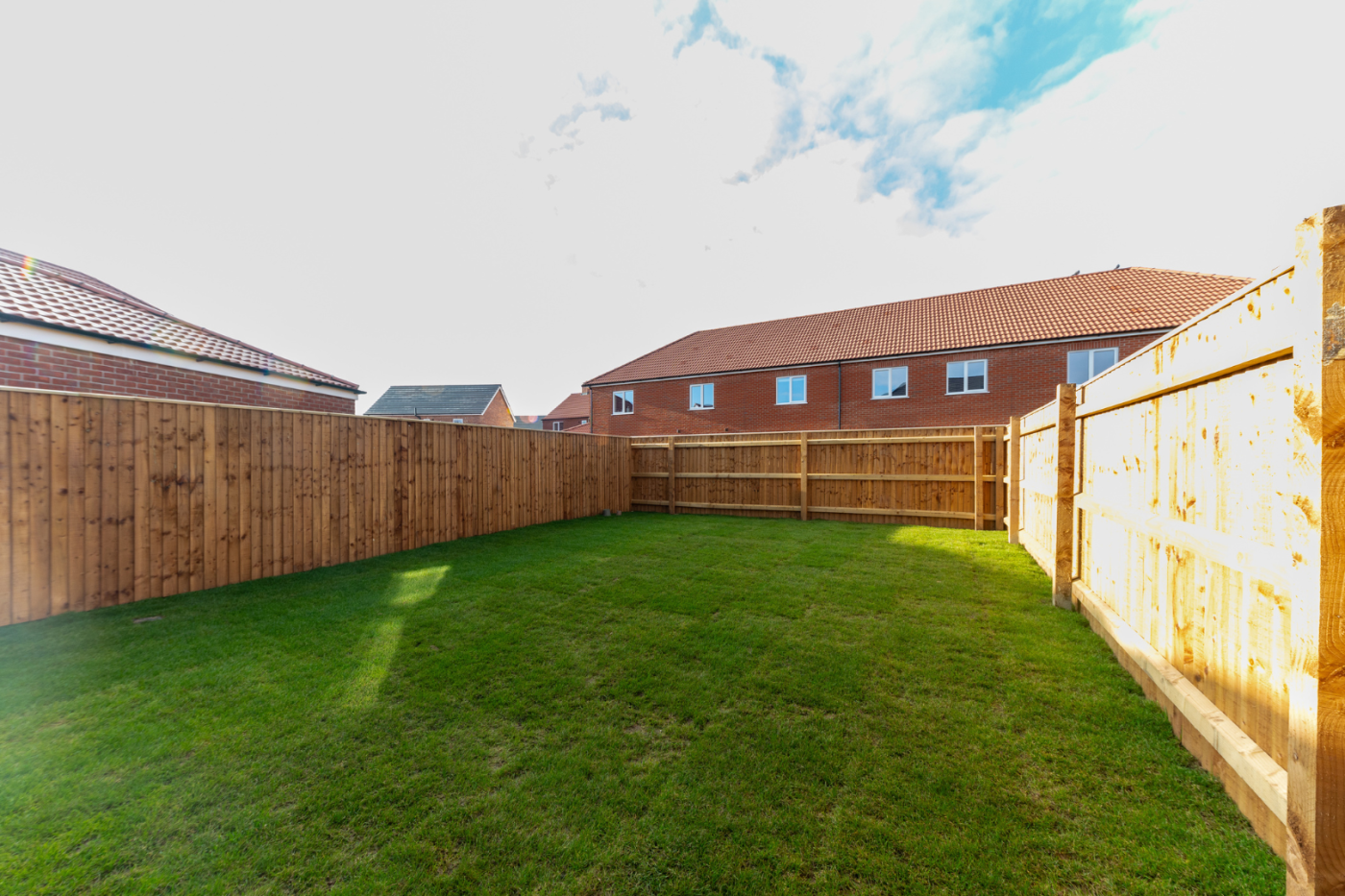 A long turfed garden in the sunshine