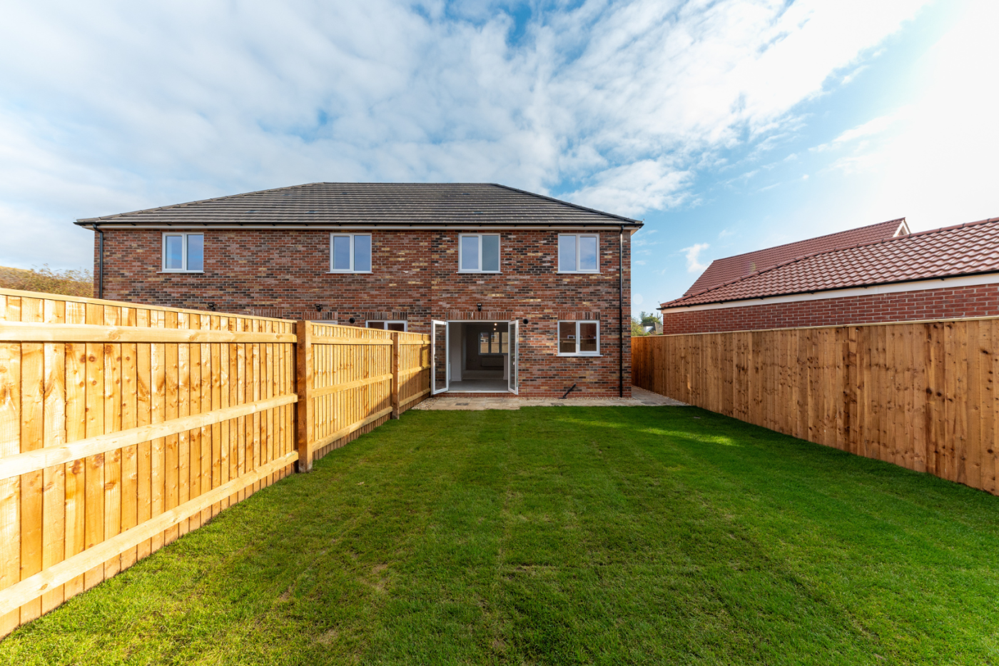A turfed garden looking towards the house