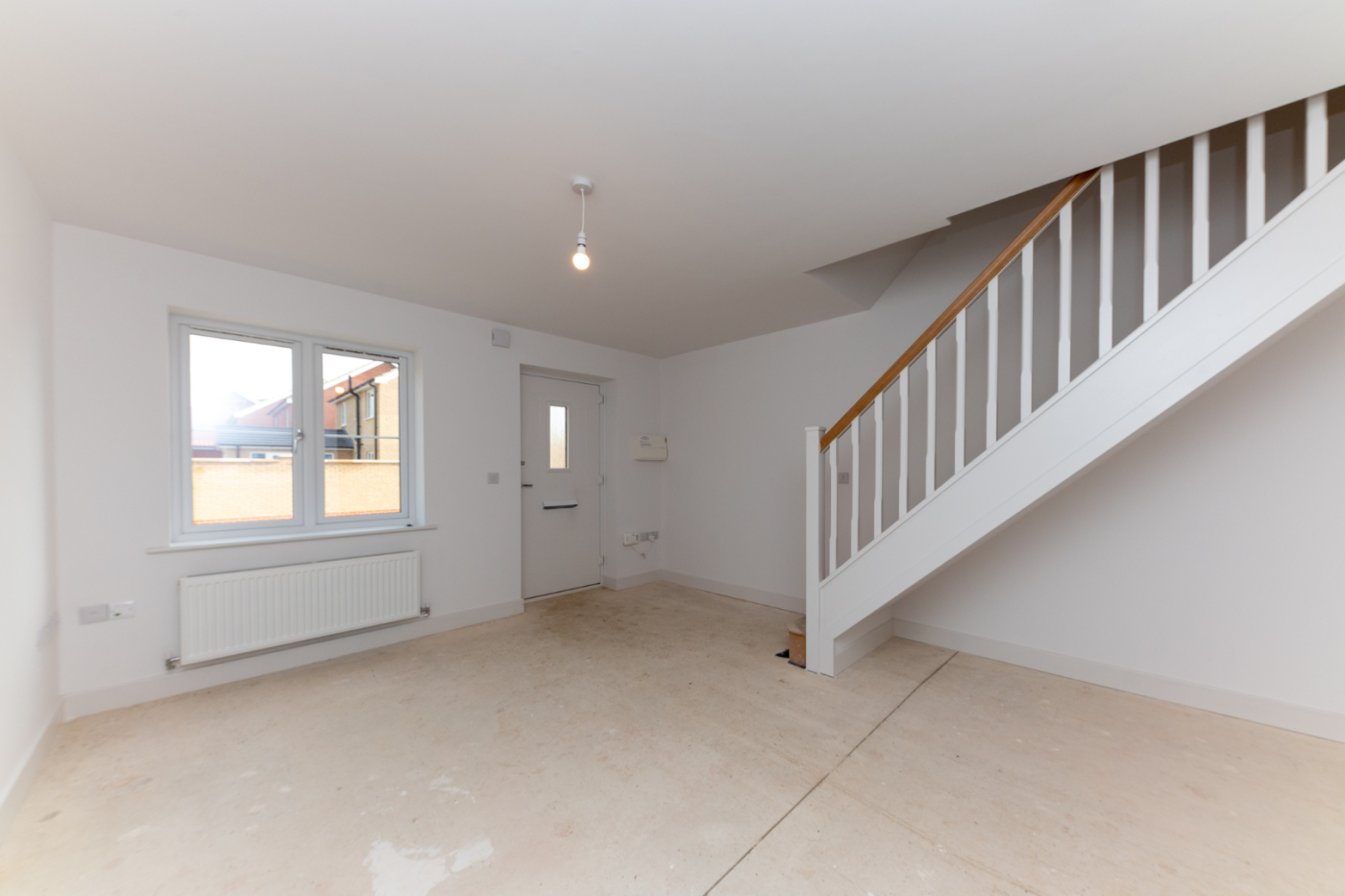 Lounge space with front door and stairs