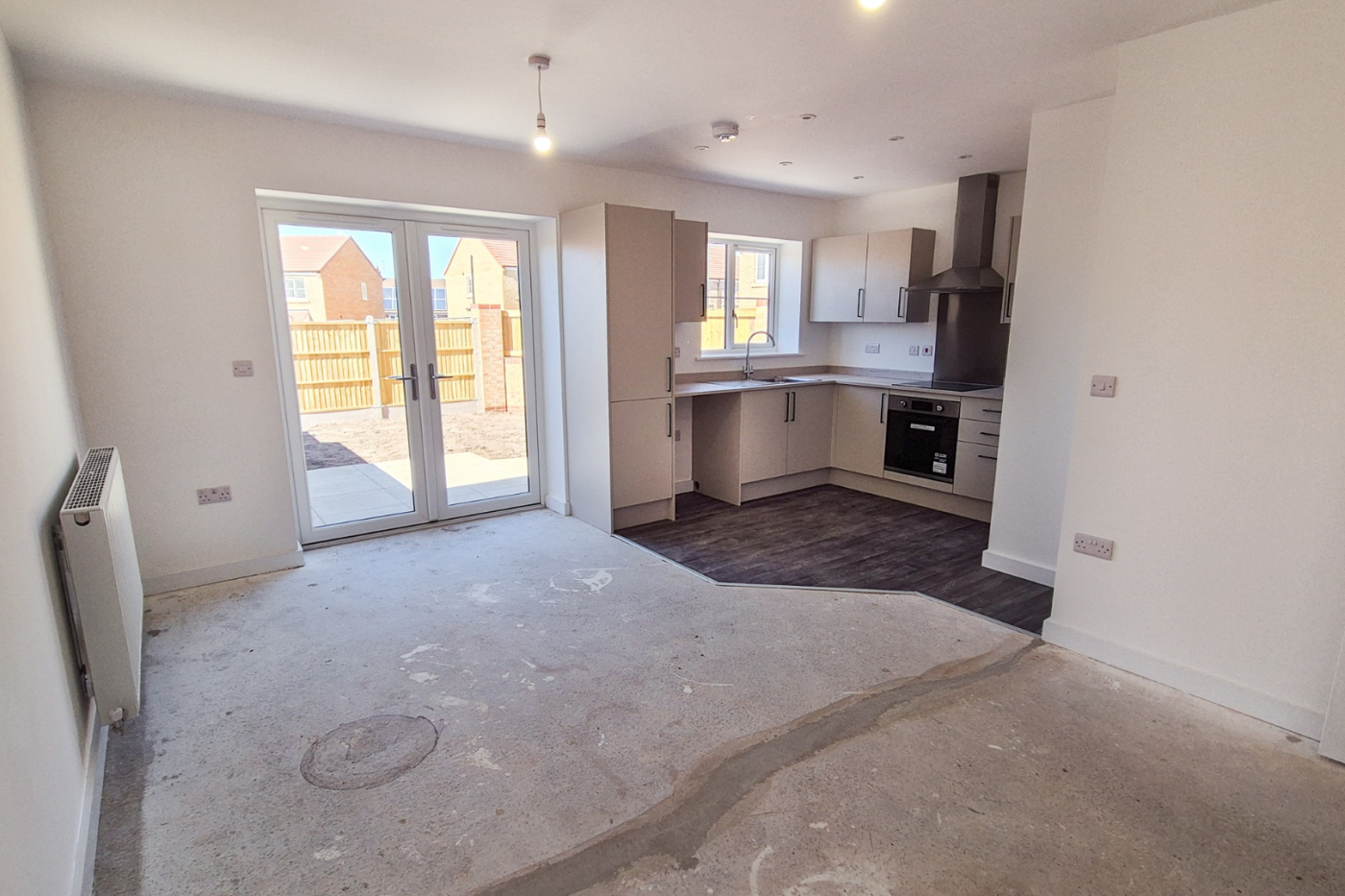 Kitchen, dining and living space with patio doors out into the garden