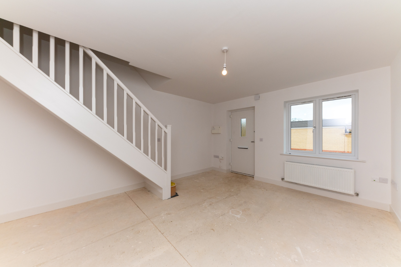 Lounge space with front door and stairs