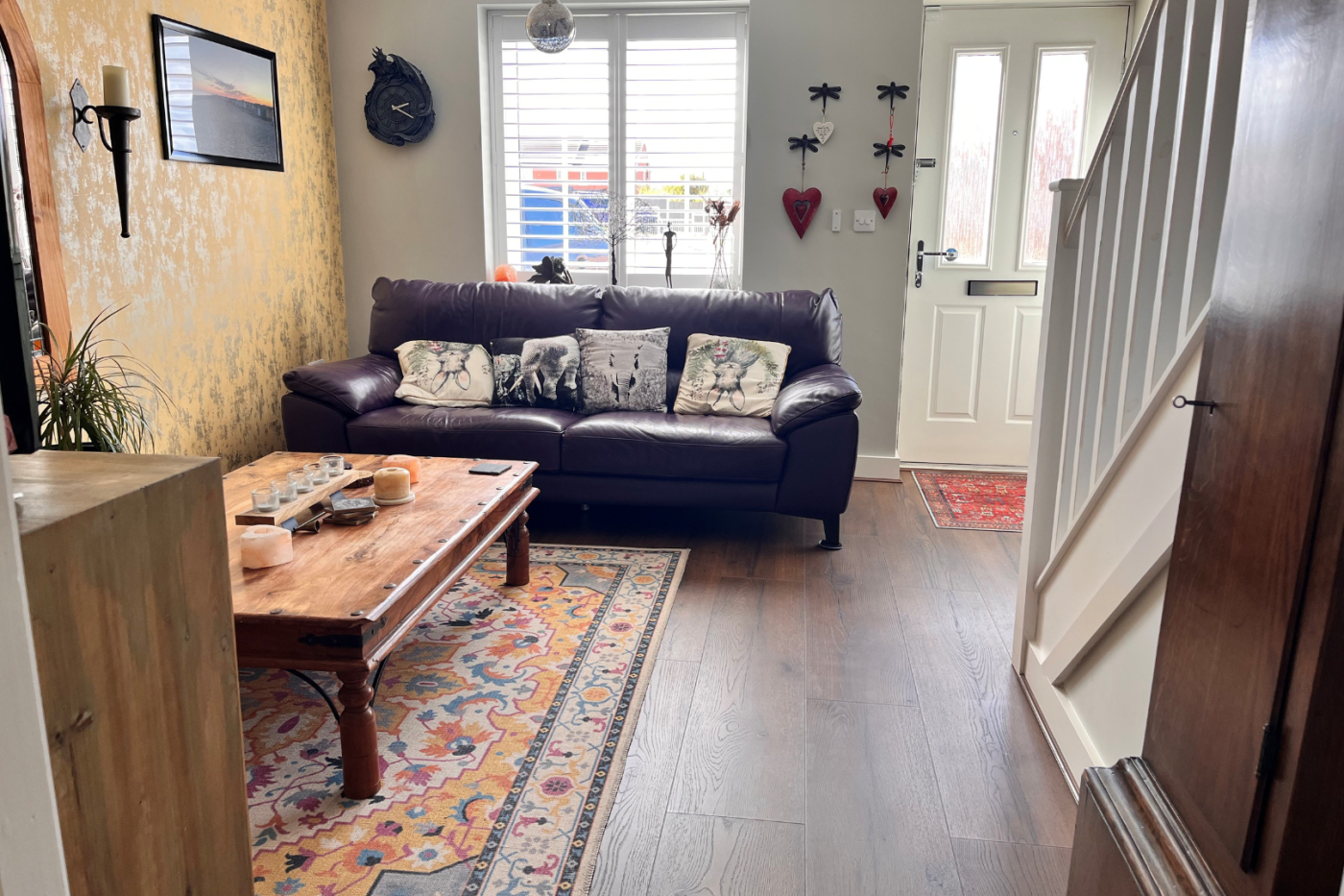 Lounge with front door, stairs and sofas