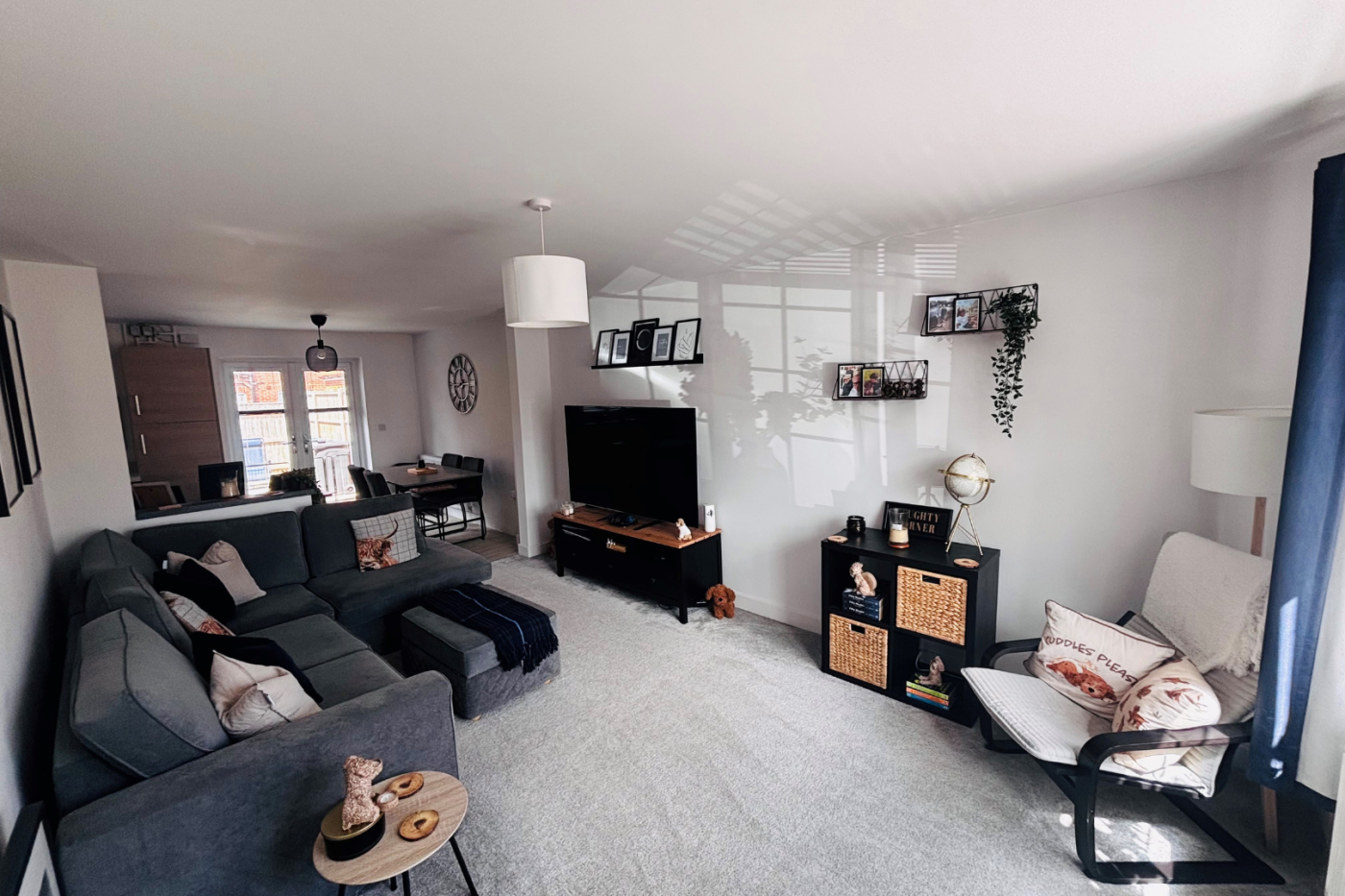 Living room with sofas, TV and cupboards