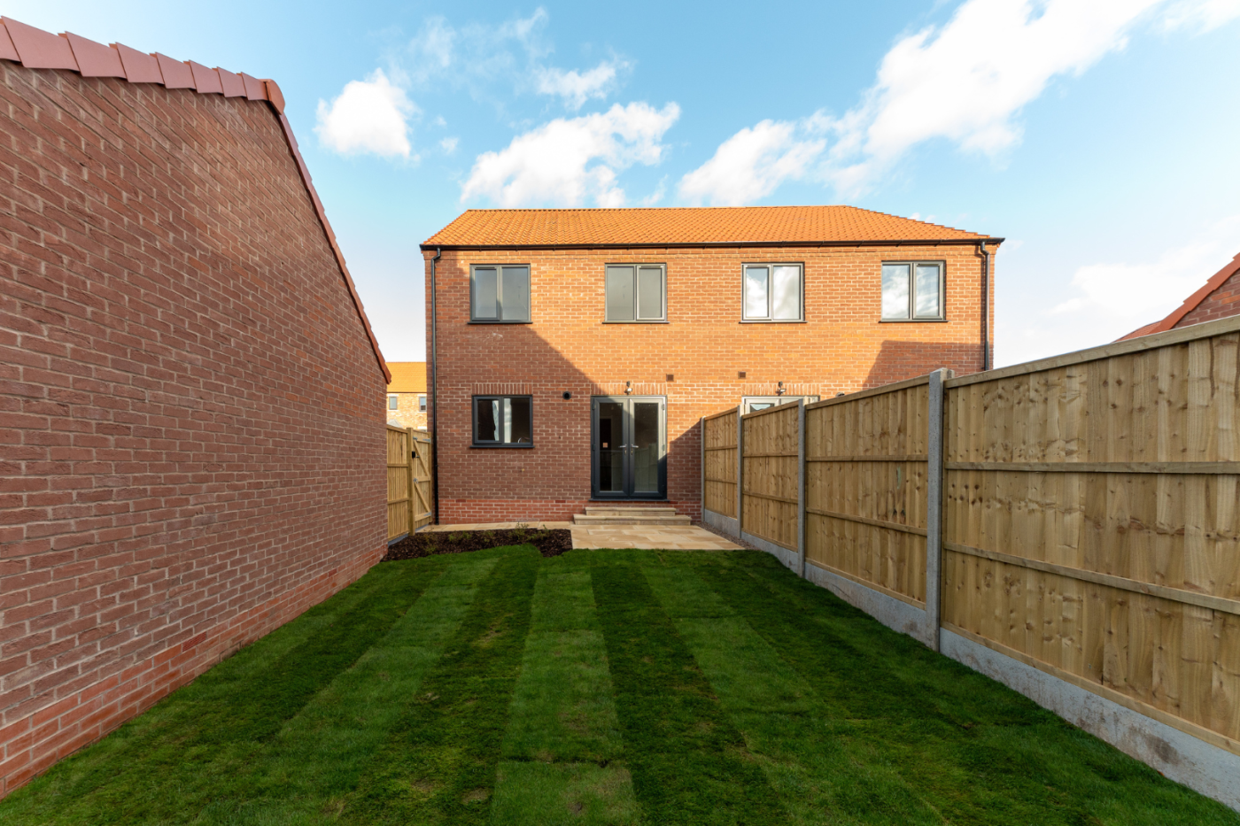 turfed garden looking towards a house