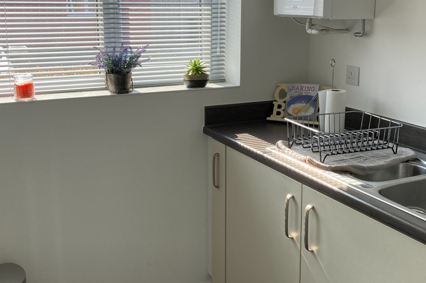 A photo of the kitchen showing the sink and window