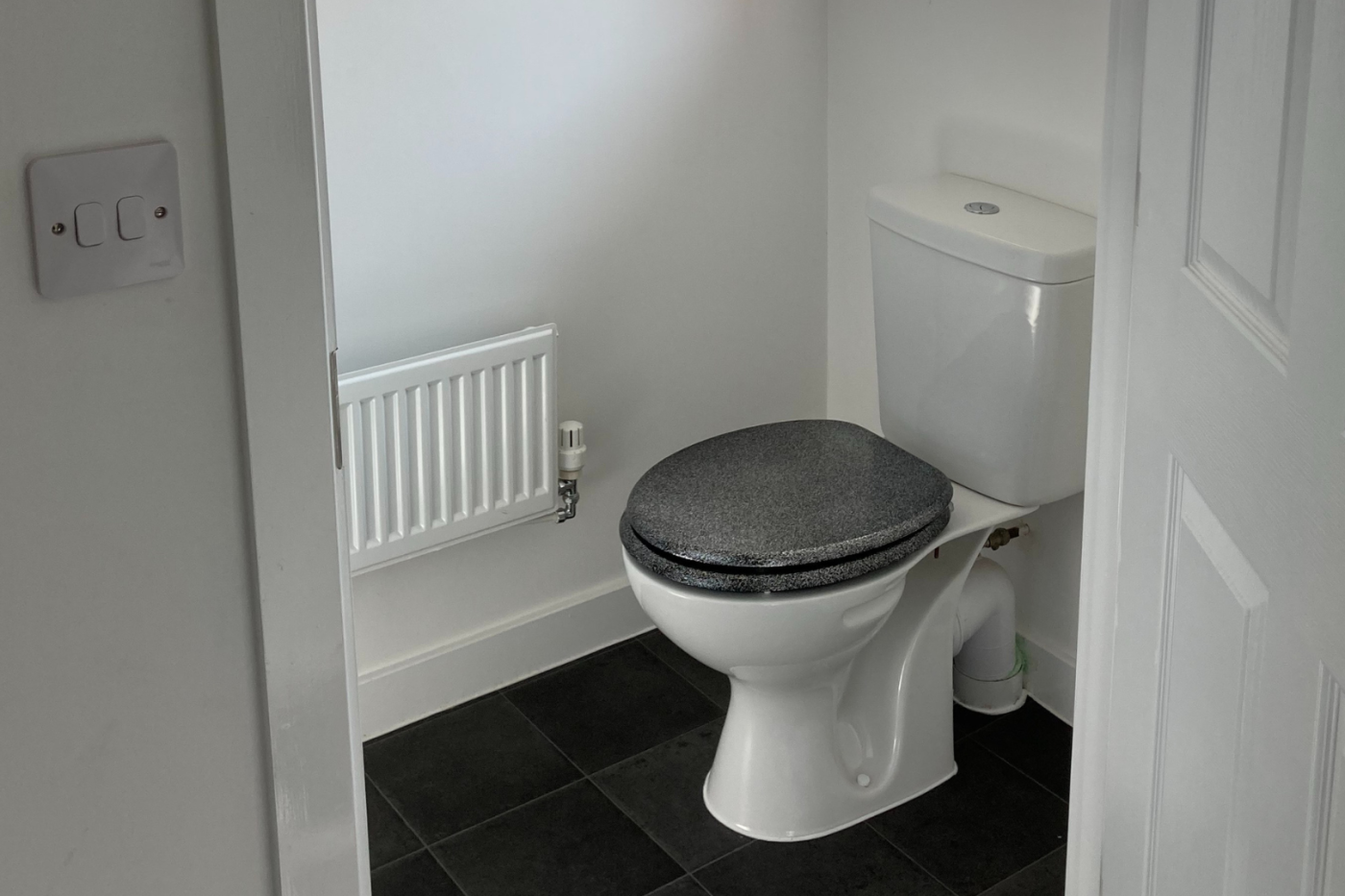A photo of a water closet showing the toilet