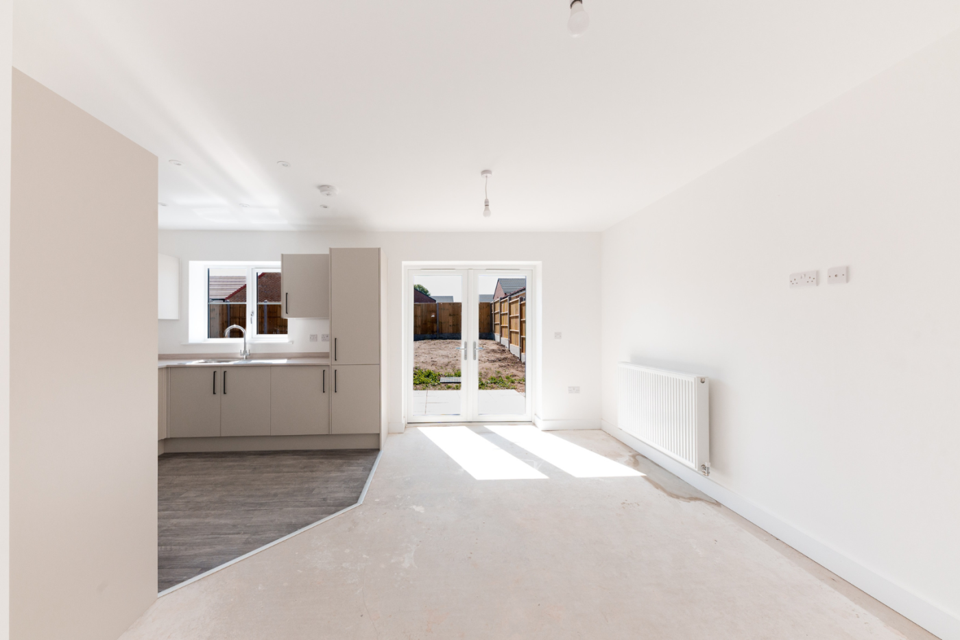 Kitchen, dining and living space with patio doors out into the garden