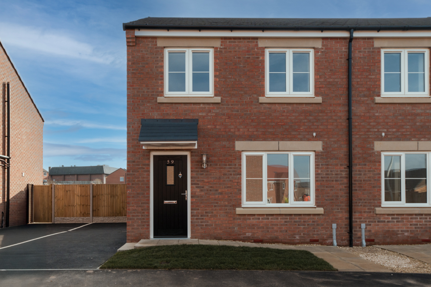 Front of a semi detached house with a driveway