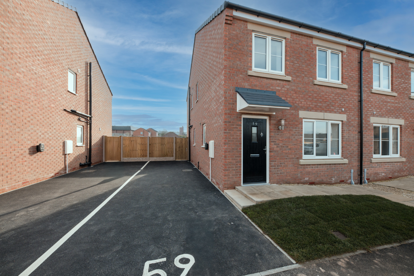 Front of a semi detached house with a driveway