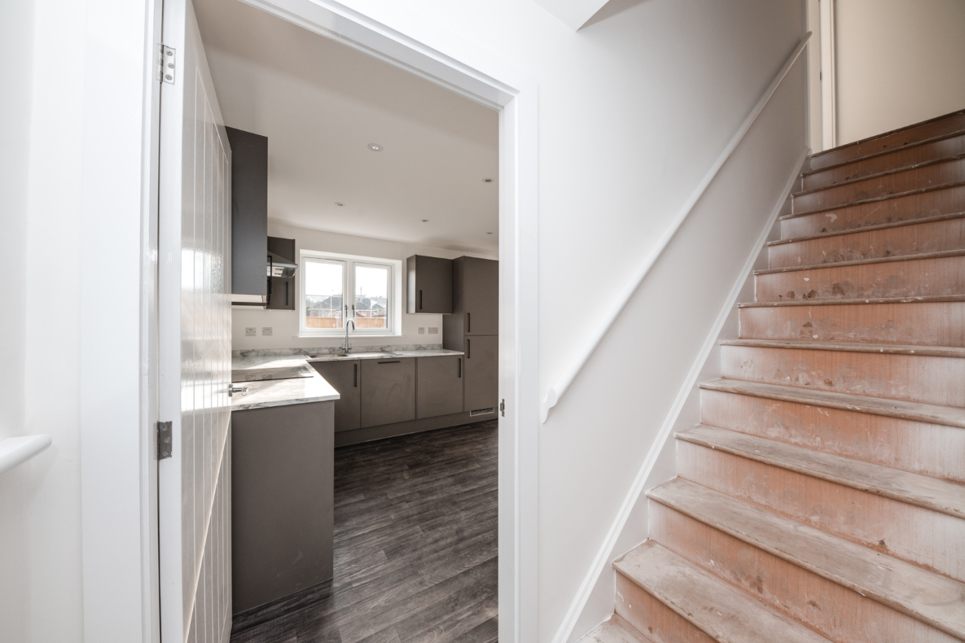 Hallway with stairs and heading towards the kitchen