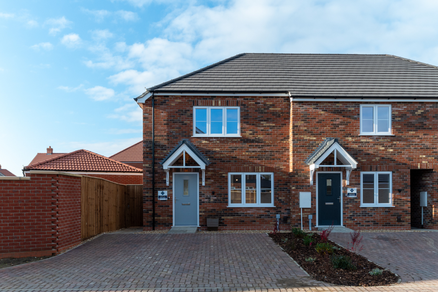 Front of 24 Bramley Close, end of a terrace of houses with the sun shining