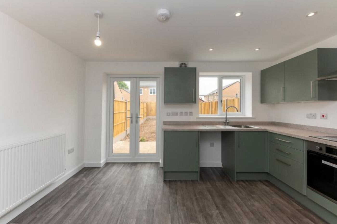 Kitchen showing doors to garden
