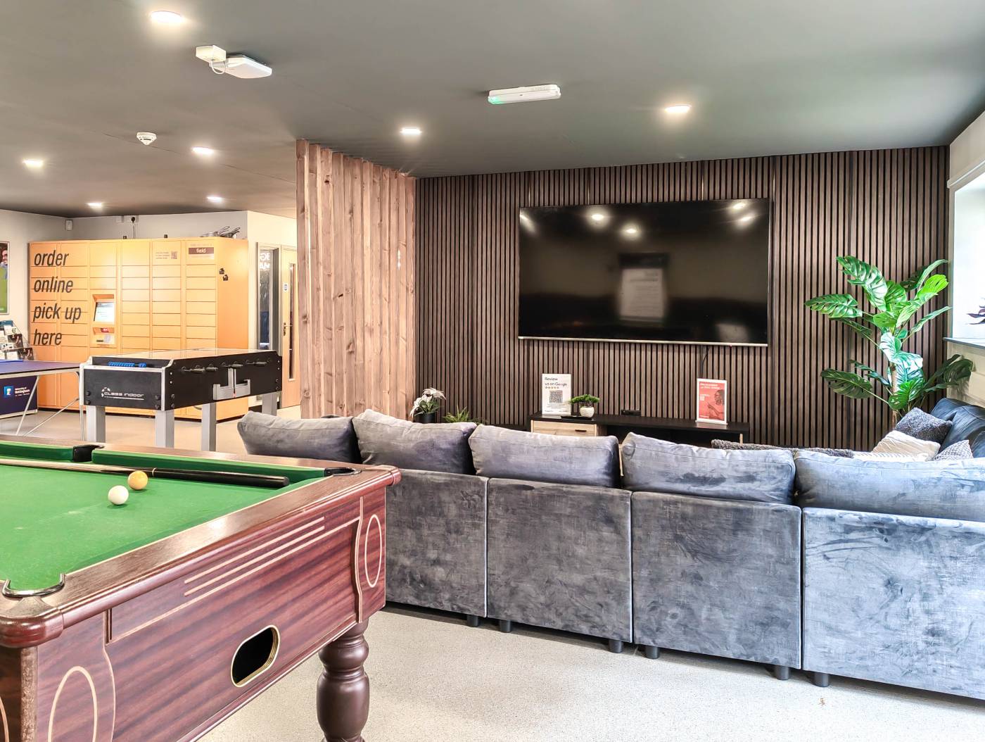 Common room with large flat screen TV and sofas