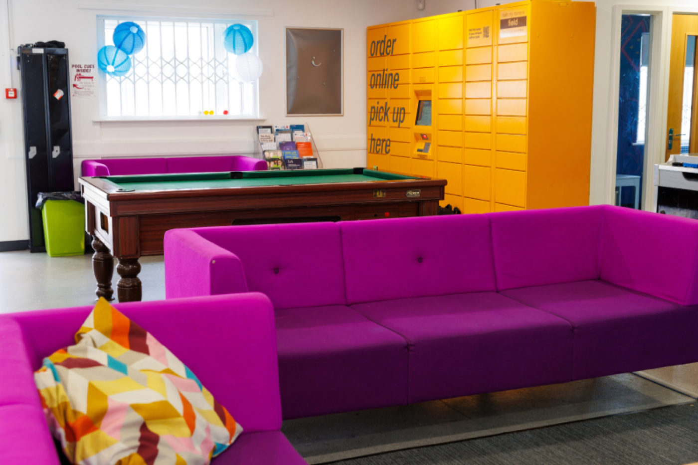 Common room with pool table and amazon lockers