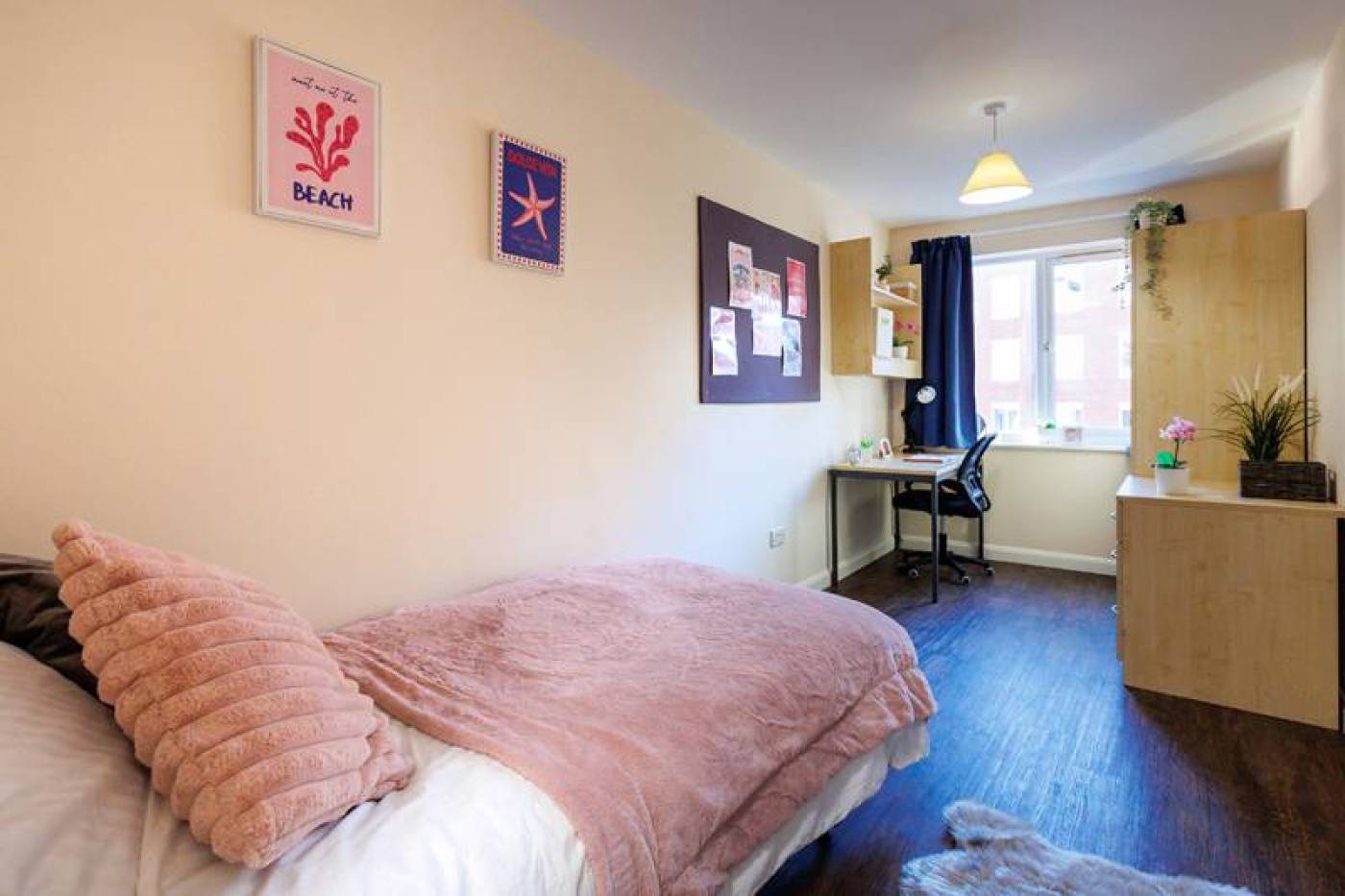 Student room with single bed, wardrobe and desk