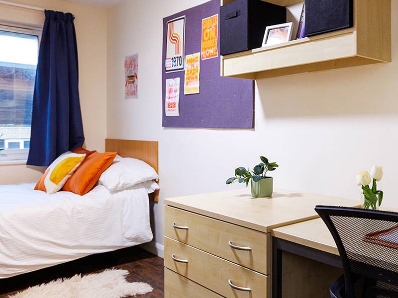 Bedroom with bed, desk and window