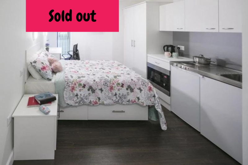 Studio room with bed, wardrobe, desk and kitchenette