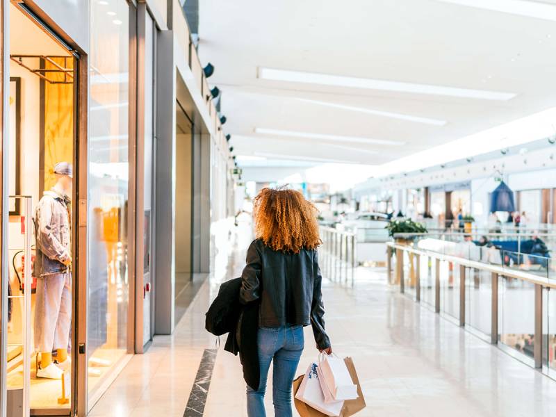 Woman in shopping centre carrying bags
