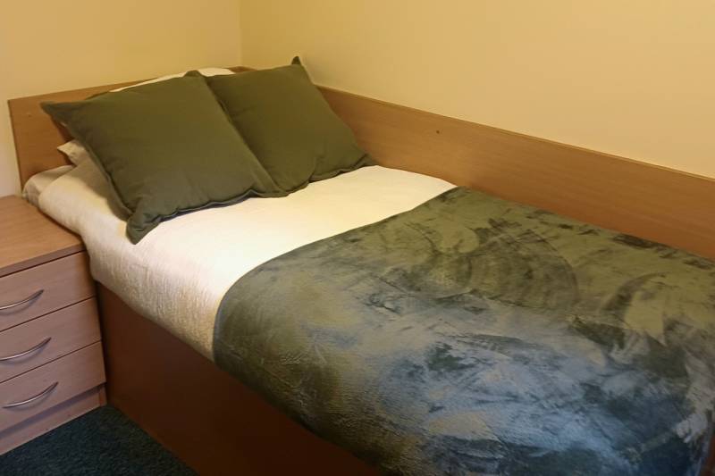 Bedroom with bed, desk and window