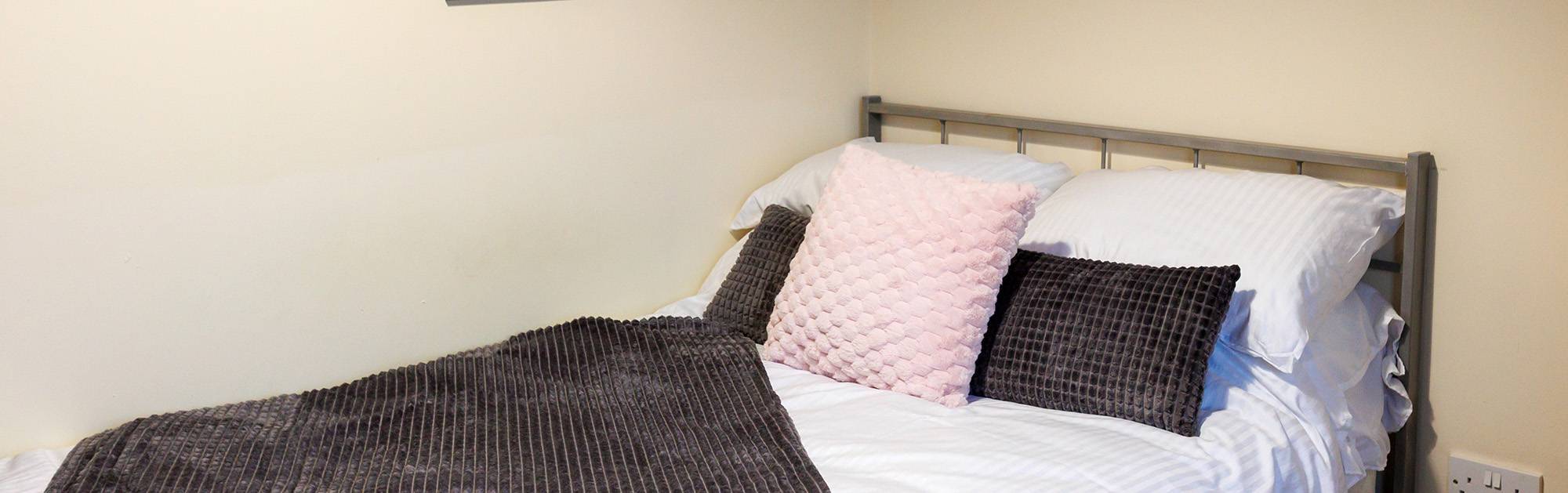 Close up of bed with cushions