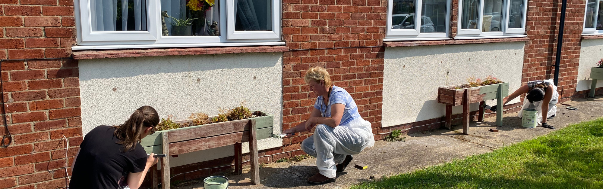 People painting raised planters