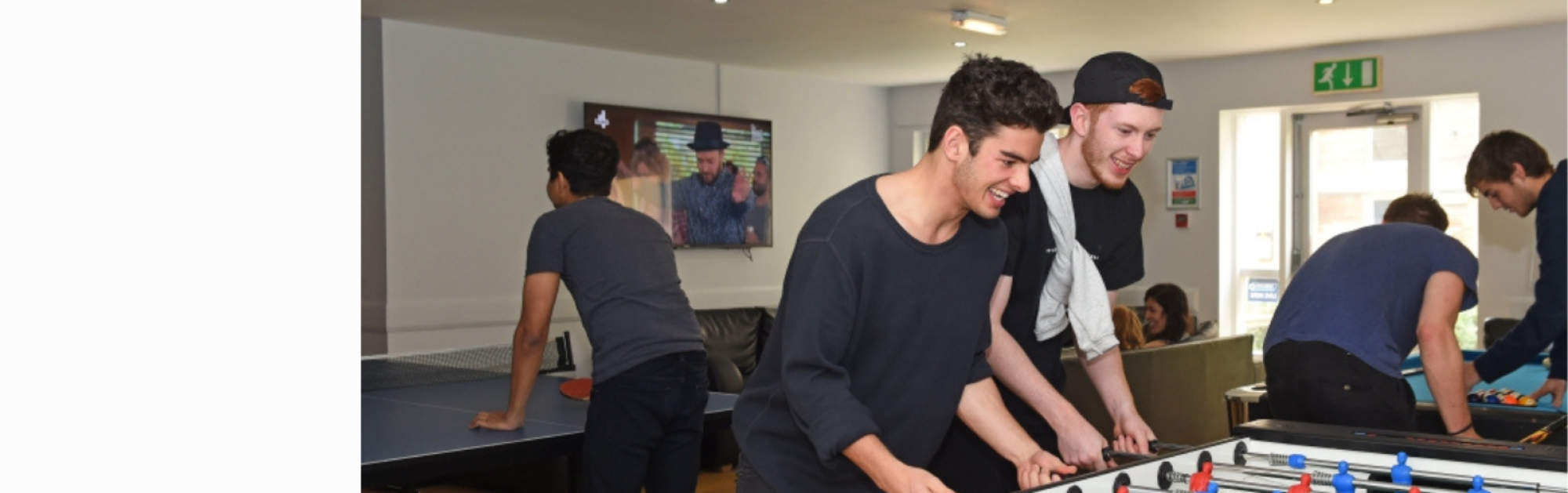 Students playing table games in common room