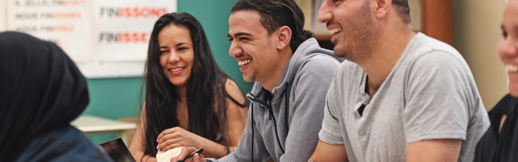 People sitting around a table learning and laughing