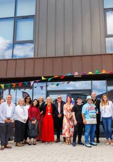 A group of people standing outside a modern community hub
