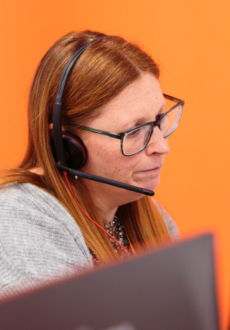 A woman speaking through a headset