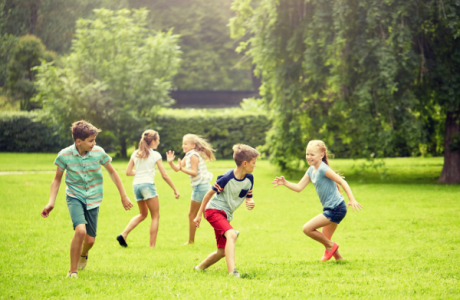 Children playing on a field in the sunshine