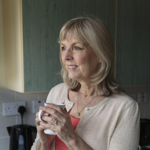 A woman holding a cup of tea