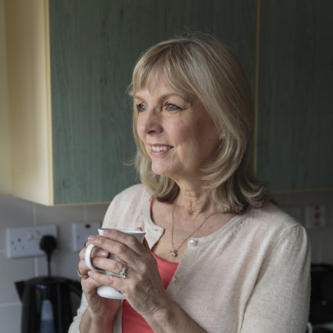 A  woman holding a cup of tea