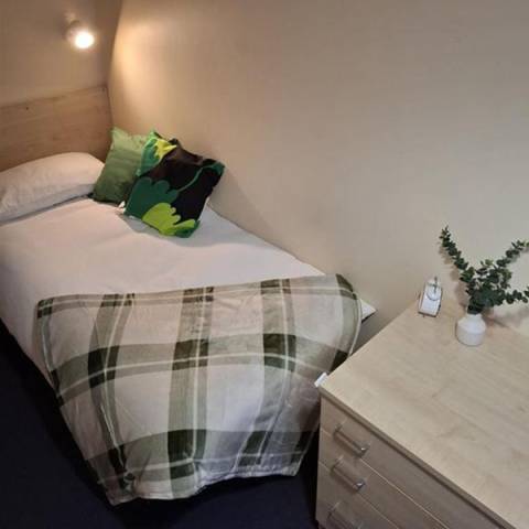 Bedroom with a single bed and study space