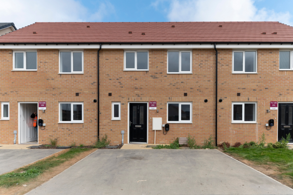 Front of a terraced row of houses with parking