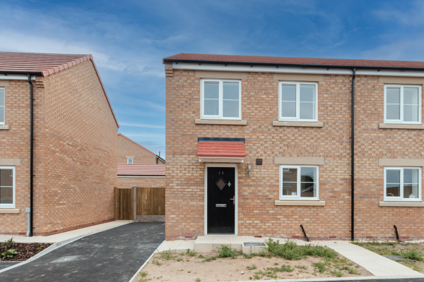 Front of a semi detached house with a driveway