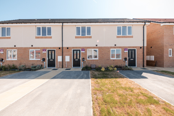 Front of a terraced row of houses with parking