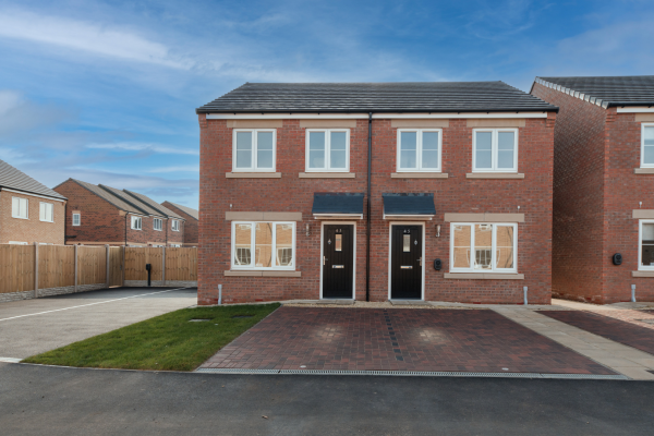 Front of a semi detached house with a driveway