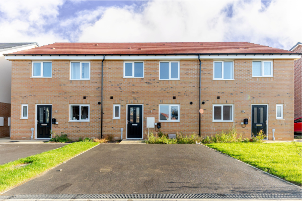 Front of a terraced row of houses with parking