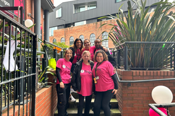 six people in pink tshirts at the trigon move-in event 